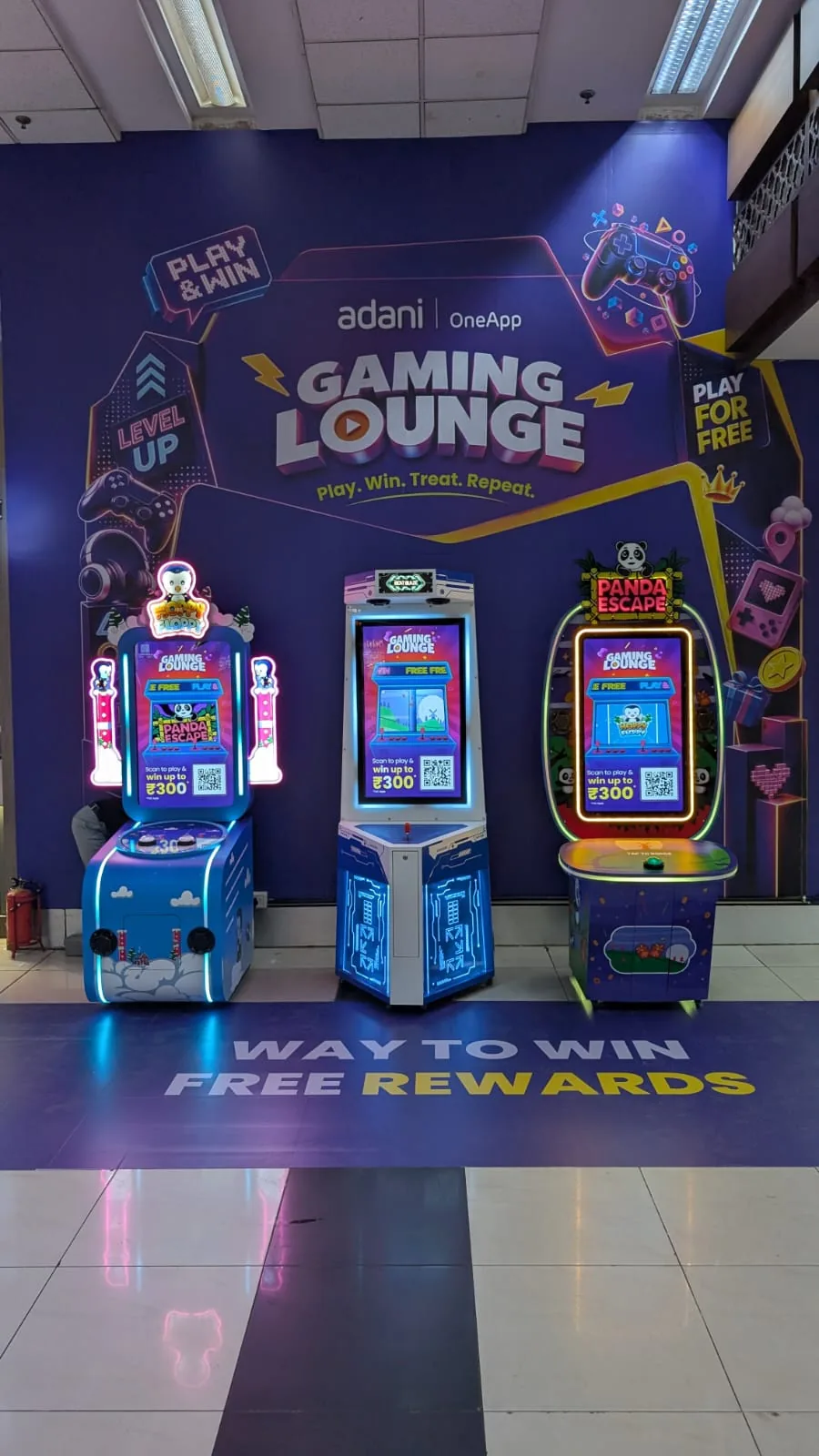 Adani One Gaming Lounge at Ahmedabad airport, with all three arcade machines powered on