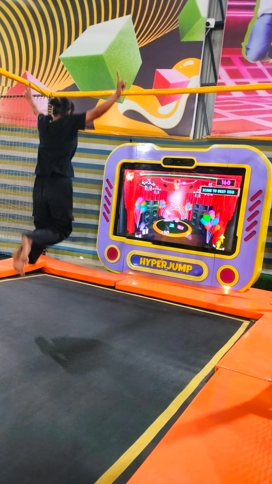 Player jumping on the trampoline in front of the Hyper Jump screen