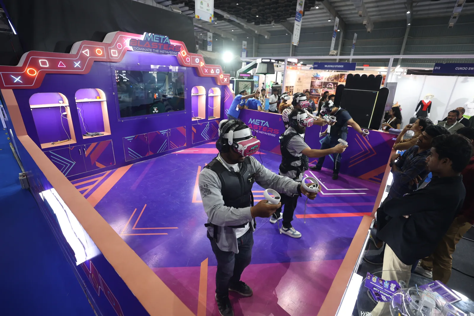 Wide view of the Metablaster VR arena with players in vests at an expo