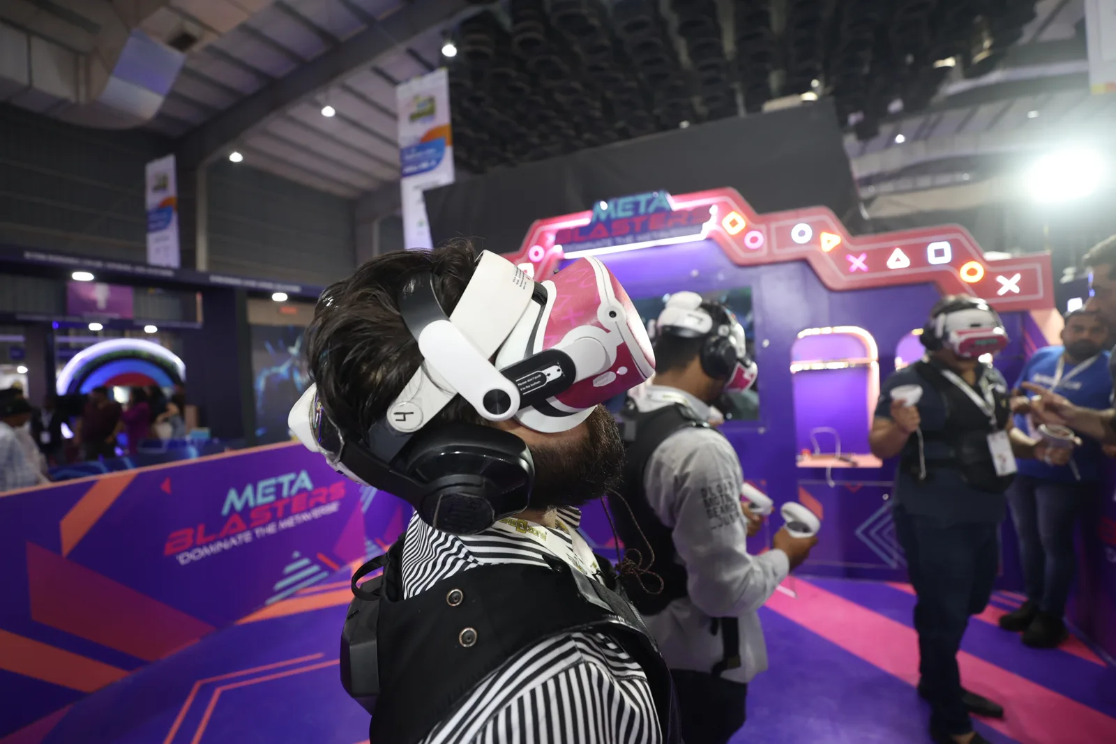 Player in headset close to camera in purple Metablaster arena at expo