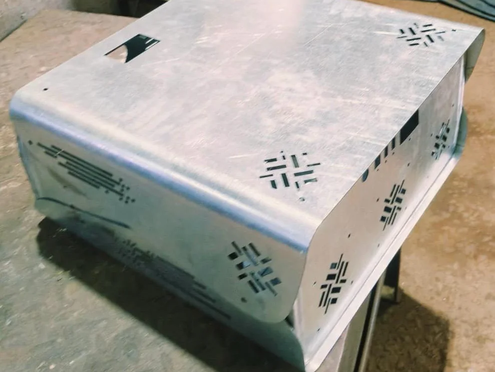 Bent and laser-cut sheet metal enclosure with ventilation cut-outs