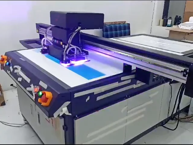 Flatbed UV printer printing a blue cabinet panel