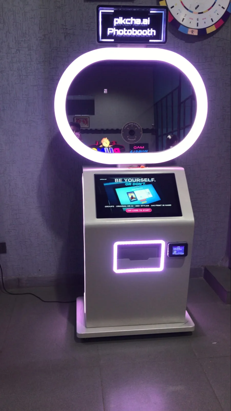 White Pikcha booth with ring light glowing at an evening venue