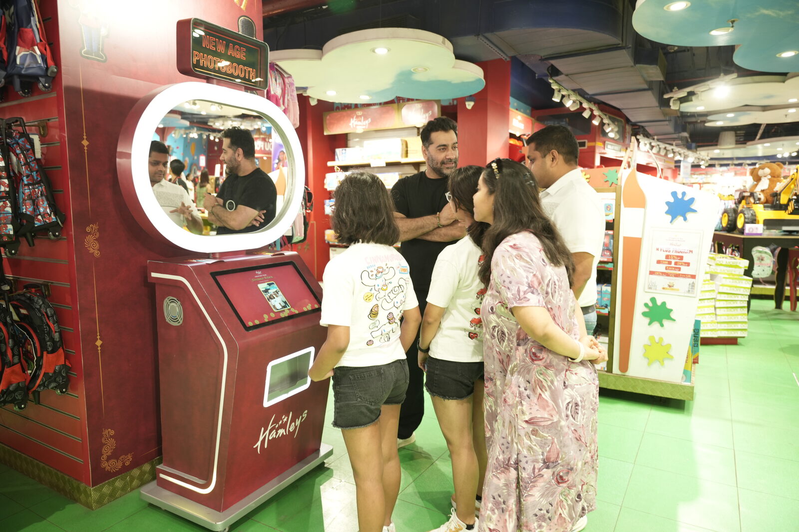 Pikcha AI photo booth installed at Hamleys in Delhi NCR, with a family at the ring-light selfie screen