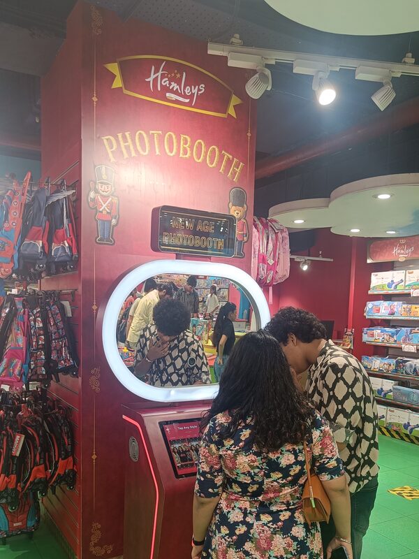Couple using the Pikcha AI photo booth at Hamleys
