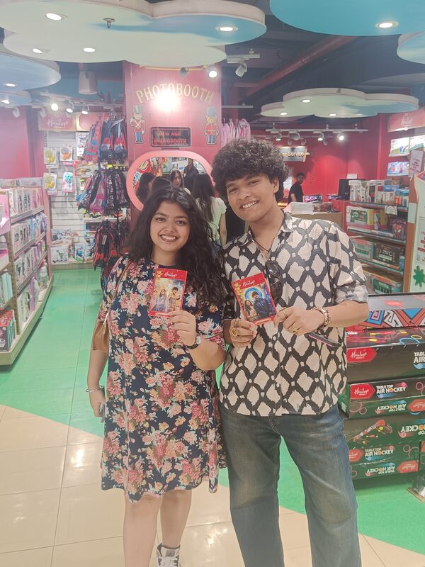Happy customers holding their printed AI photos at the Pikcha booth in Hamleys