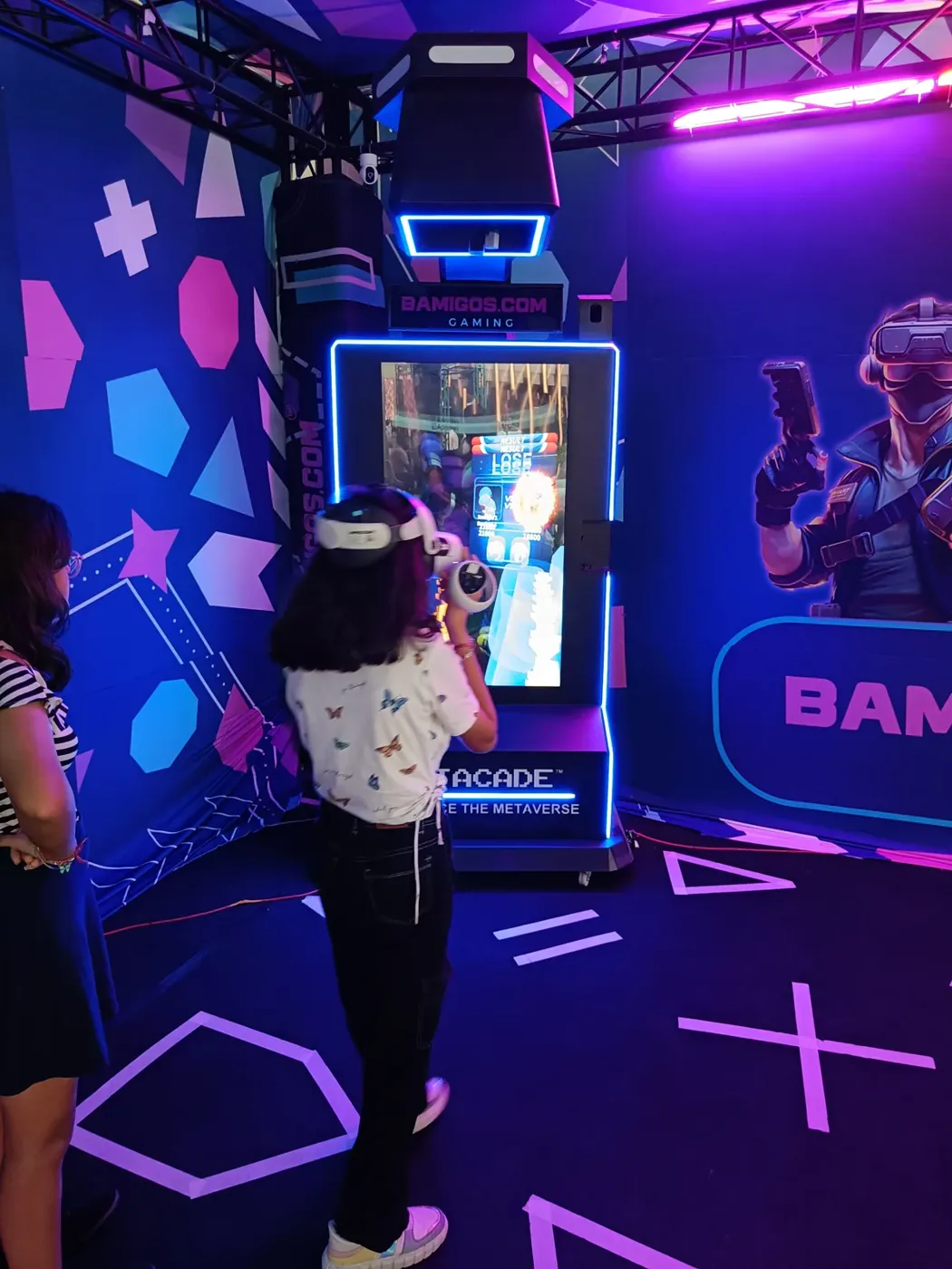 Woman in a VR headset playing the Metacade cabinet