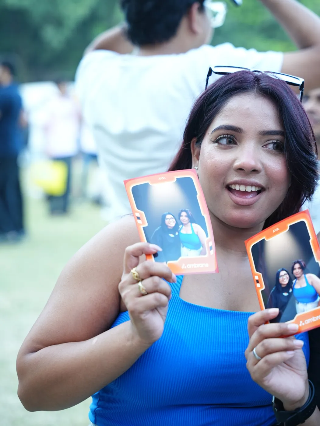 Guest holding photo booth prints in a branded frame