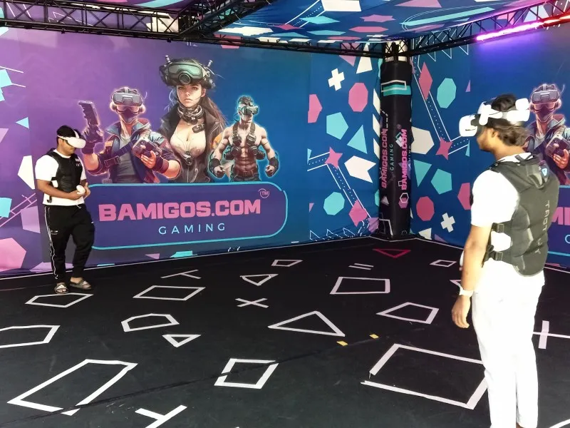 Players in VR vests inside a purple Bamigos VR arena